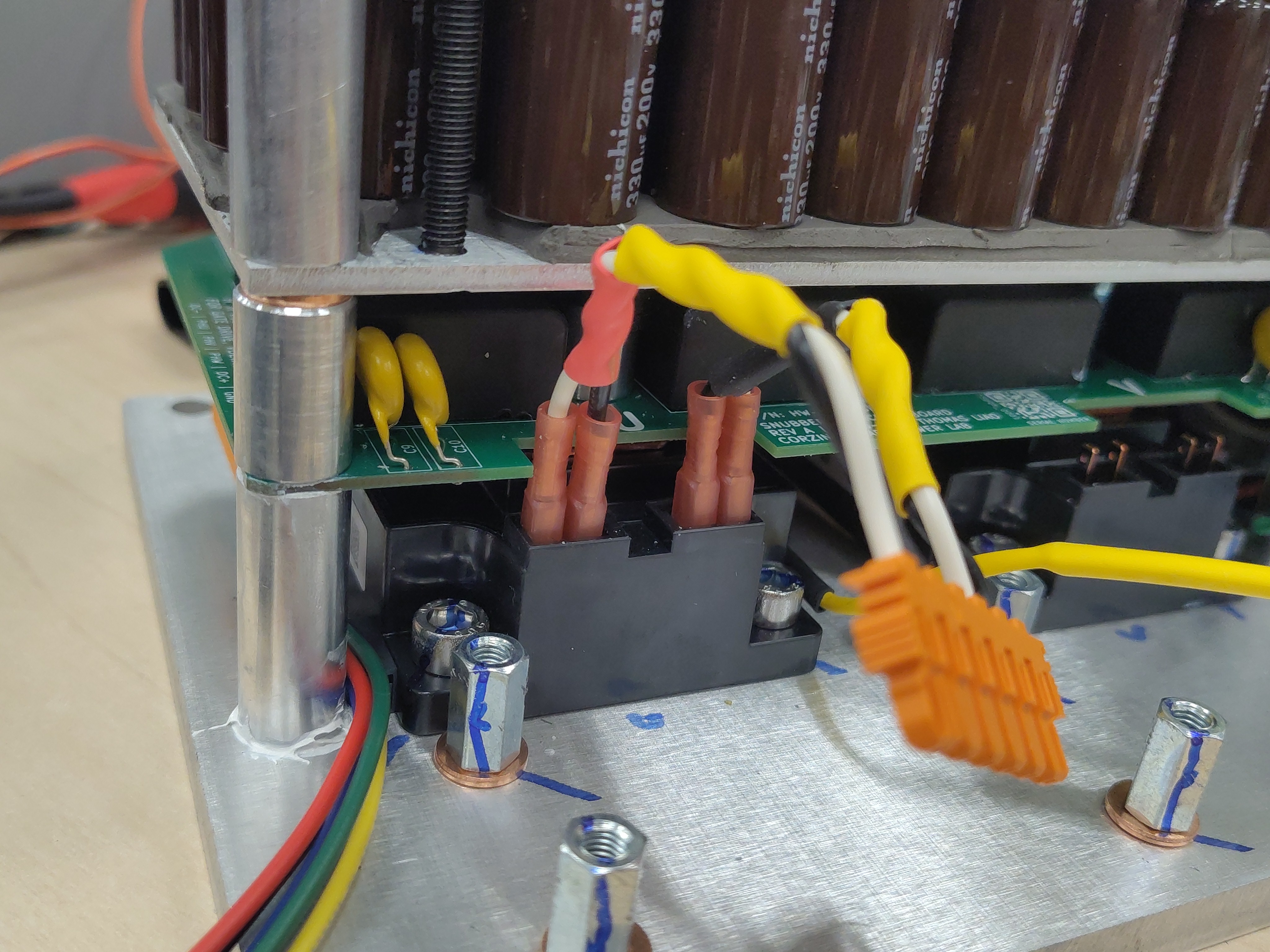 Gate-emitter pairs test-fitted onto an IGBT module's gate and emitter pins