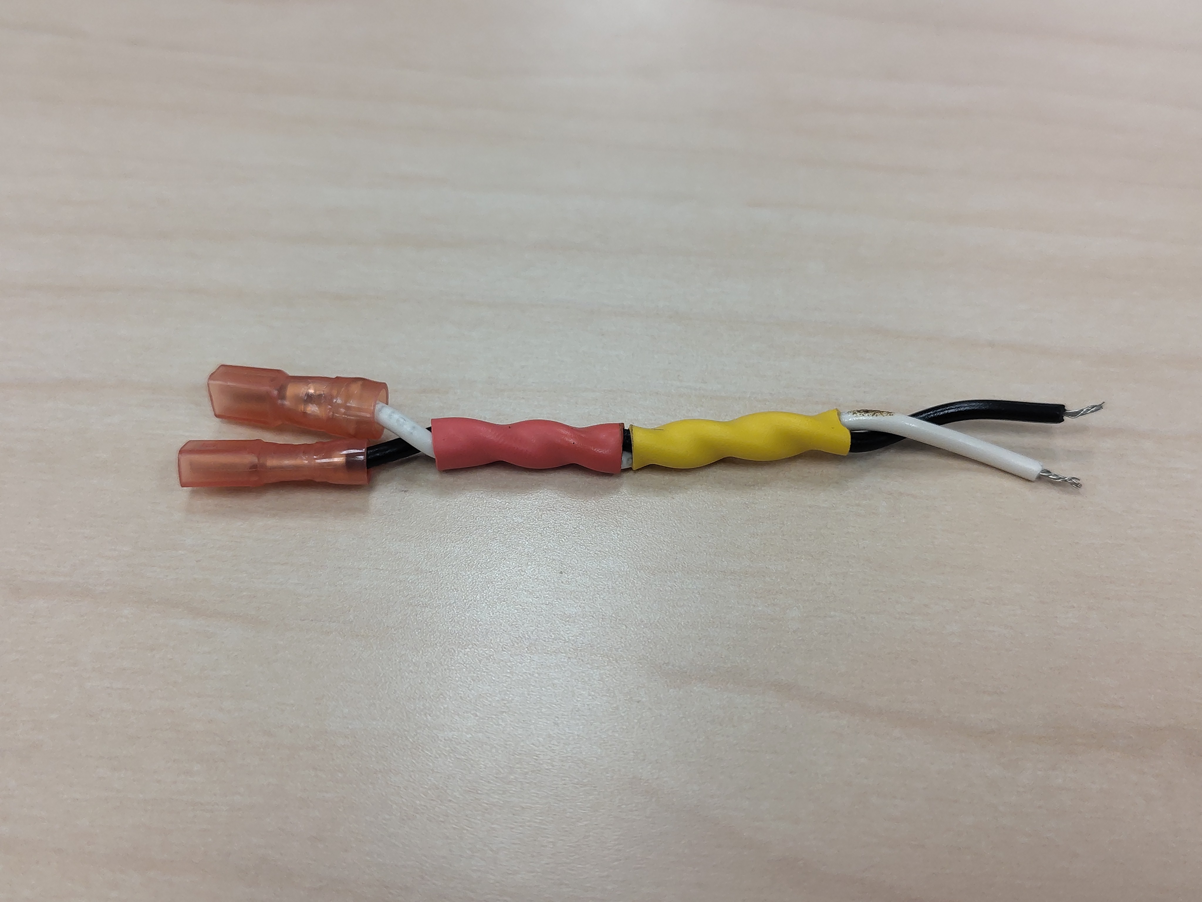 Finished high-side phase-U pair with red and yellow heat-shrink shrunk