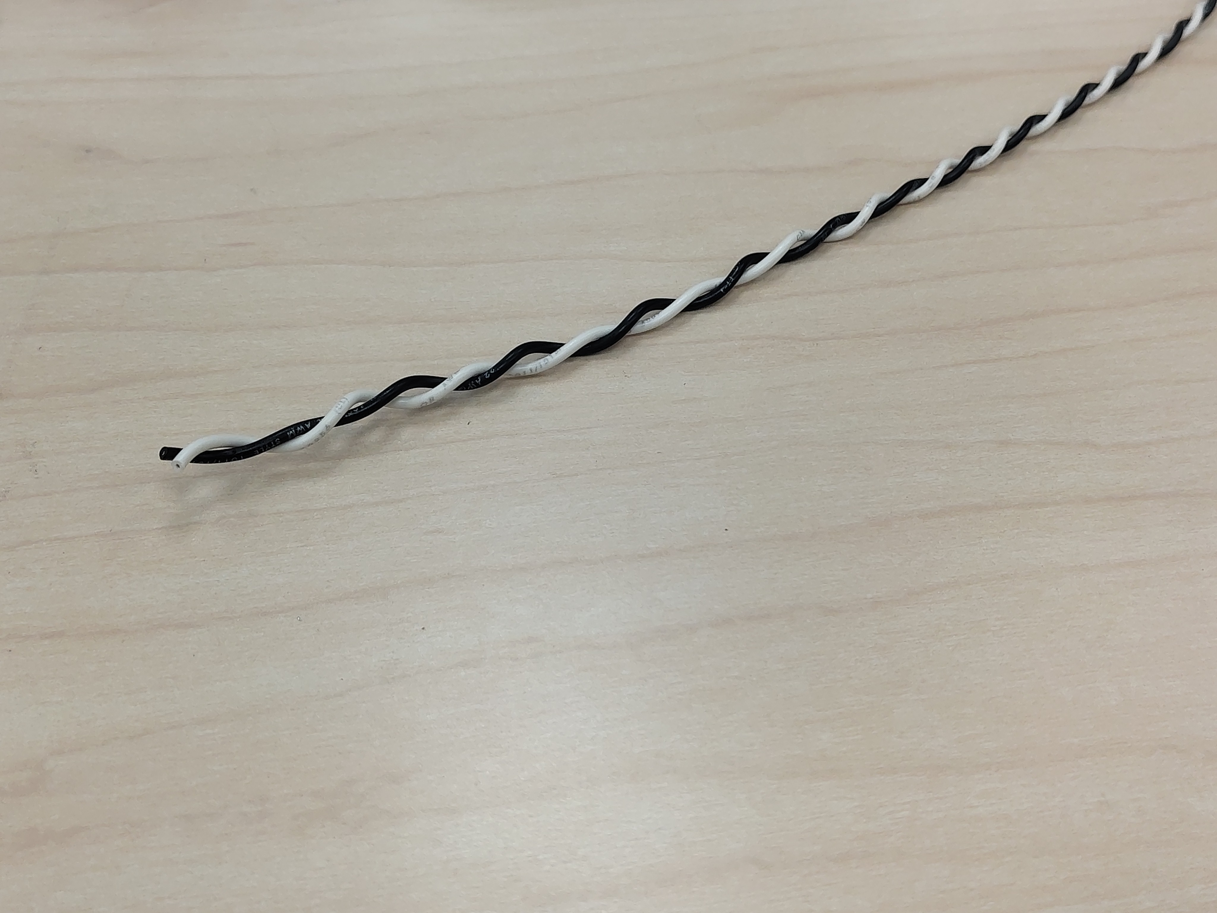 A length of black/white 18 AWG twisted-pair wire
