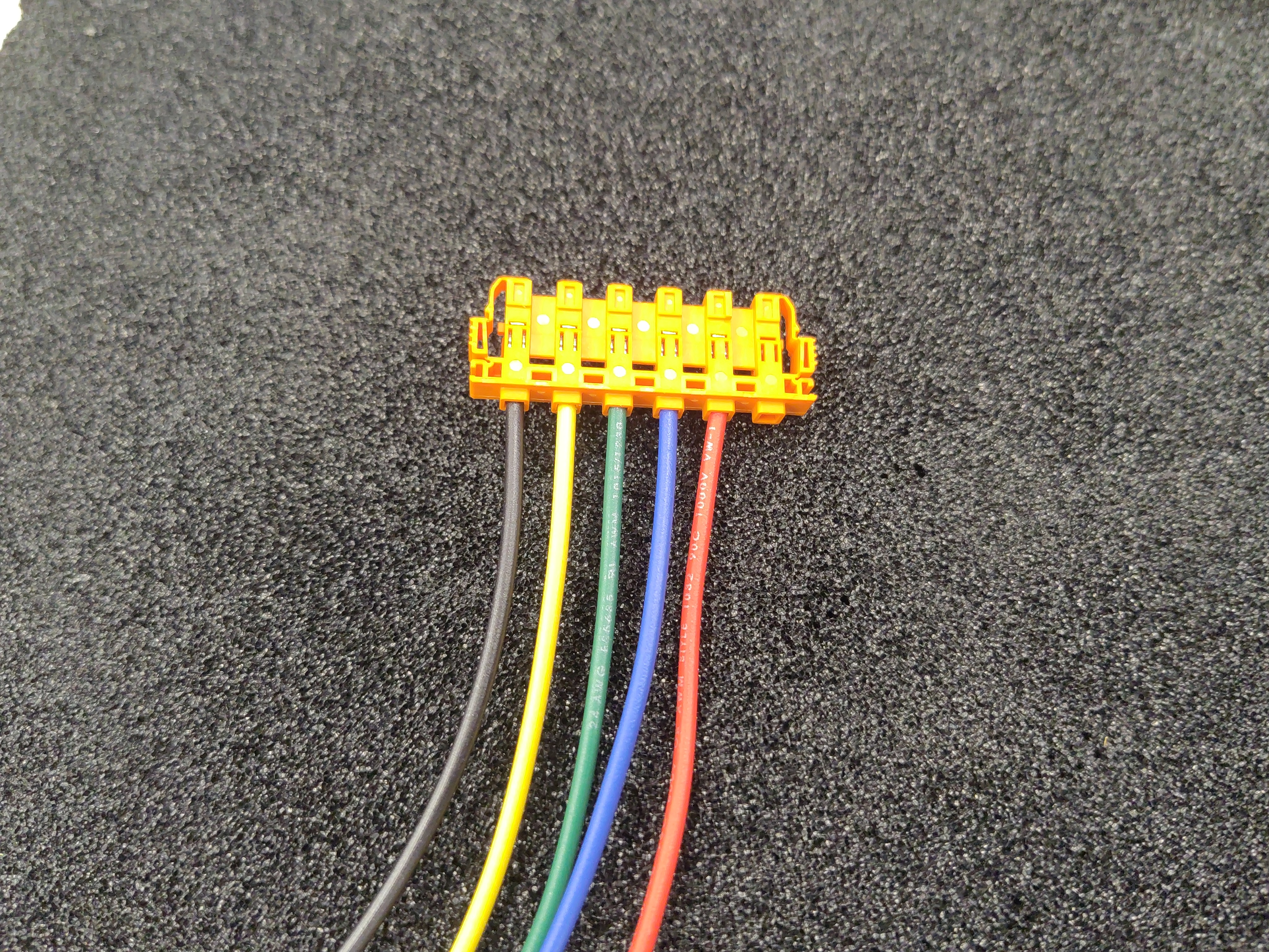 The five sense leads inserted into the orange housing