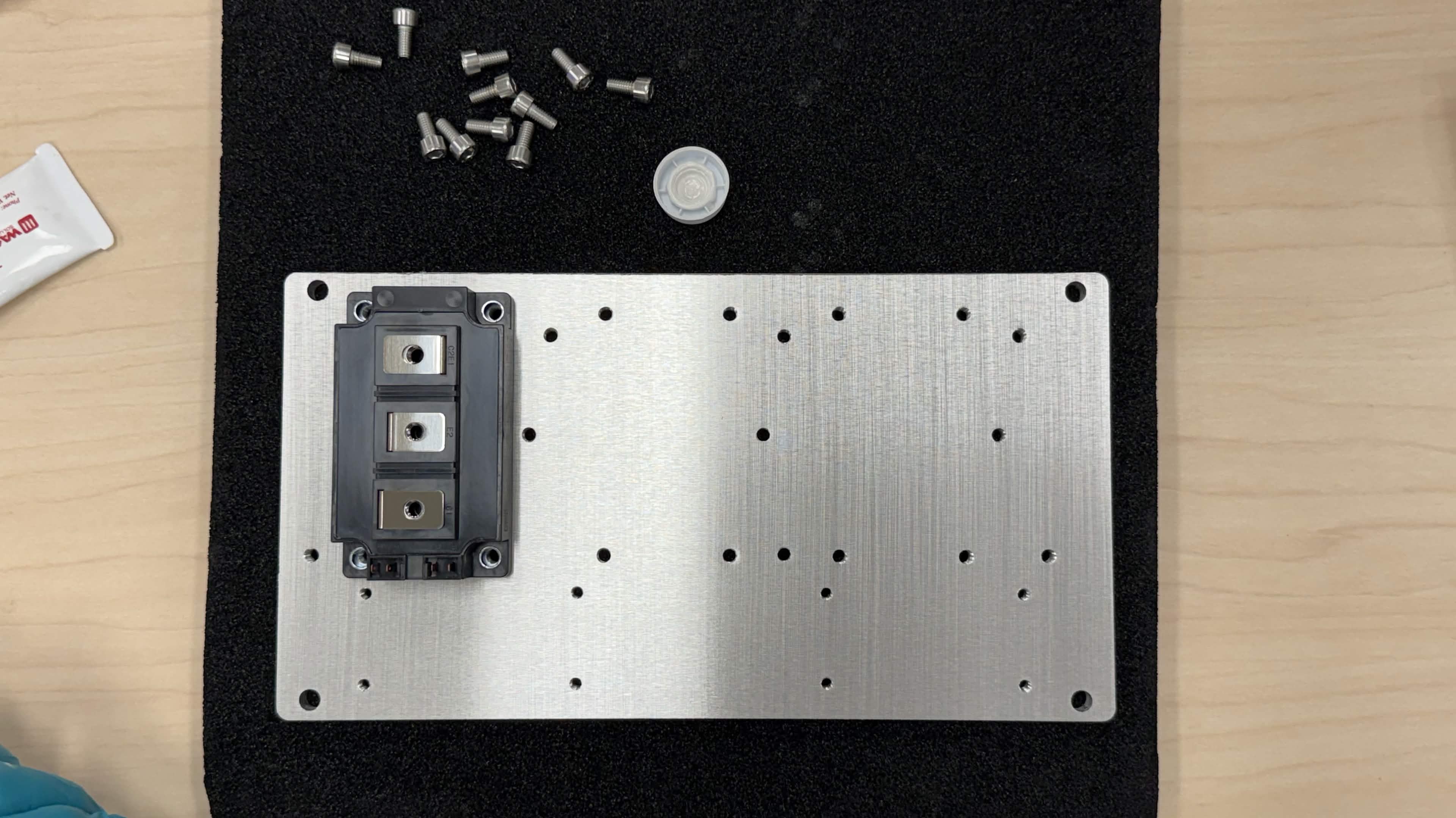 IGBT module placed onto the baseplate, aligned with mounting holes