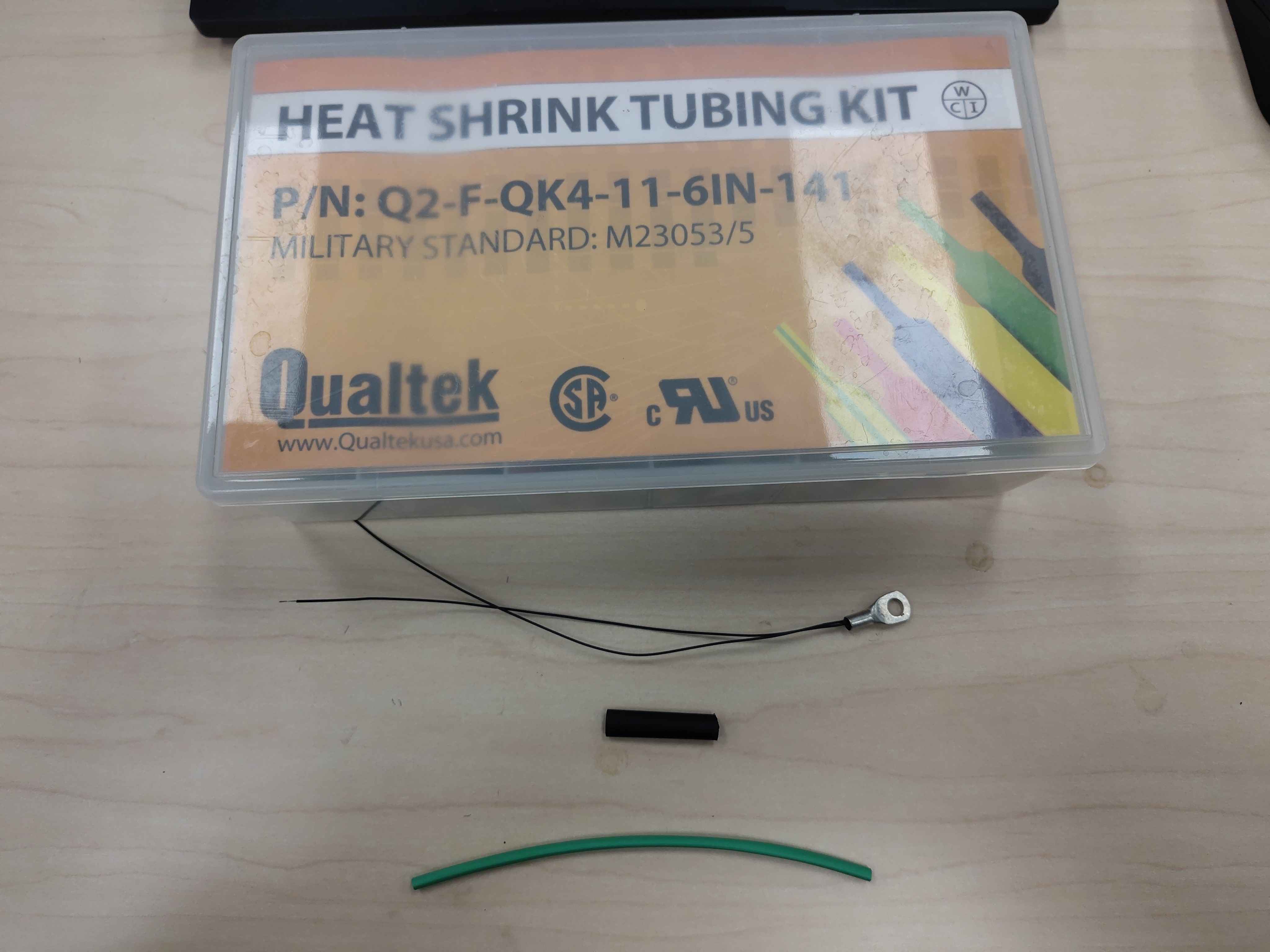 Heat-shrink pieces ready to be slid onto the sensor lead