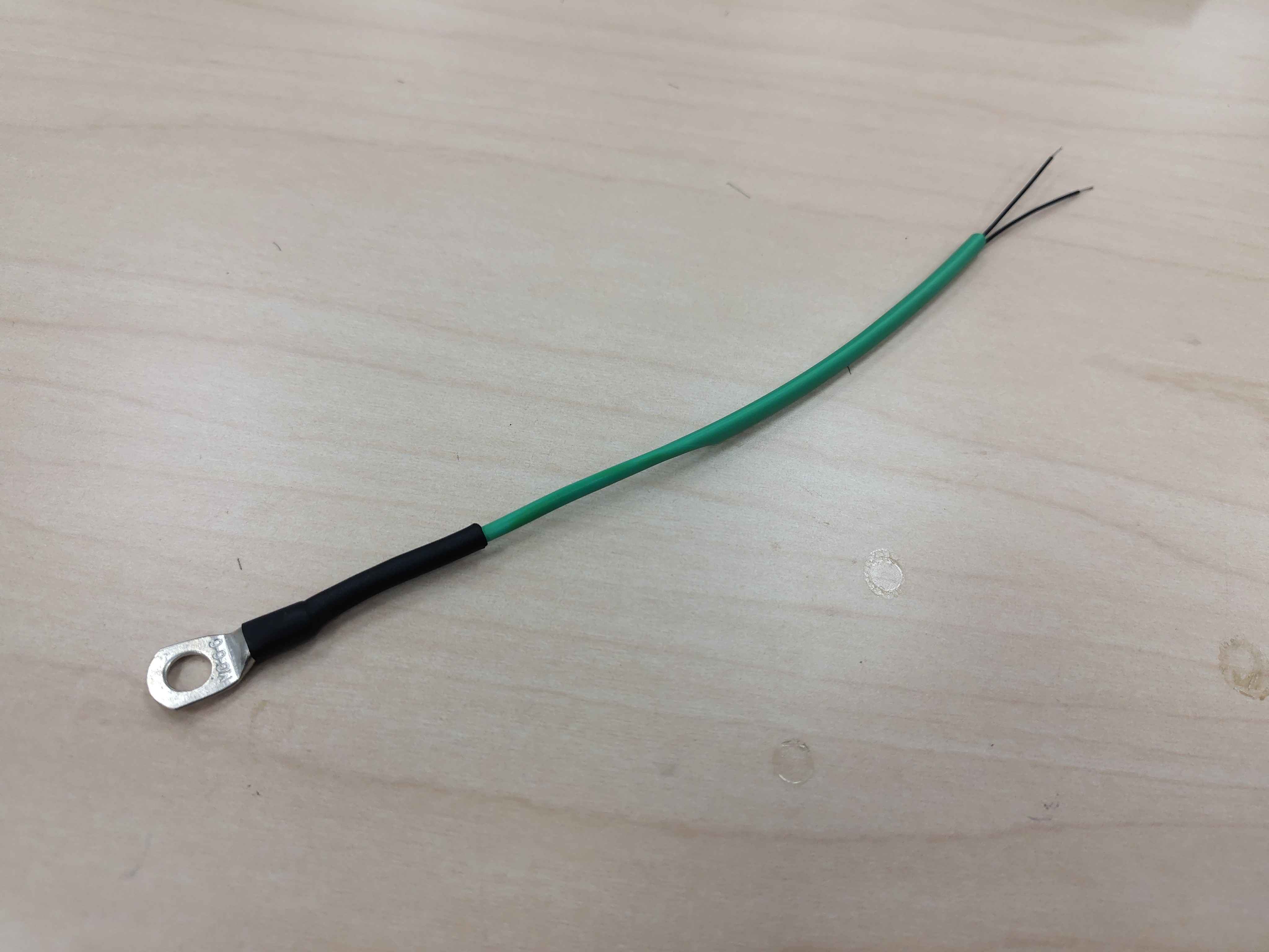 Heat-shrink partially shrunk near the ring lug, leaving the rest flexible
