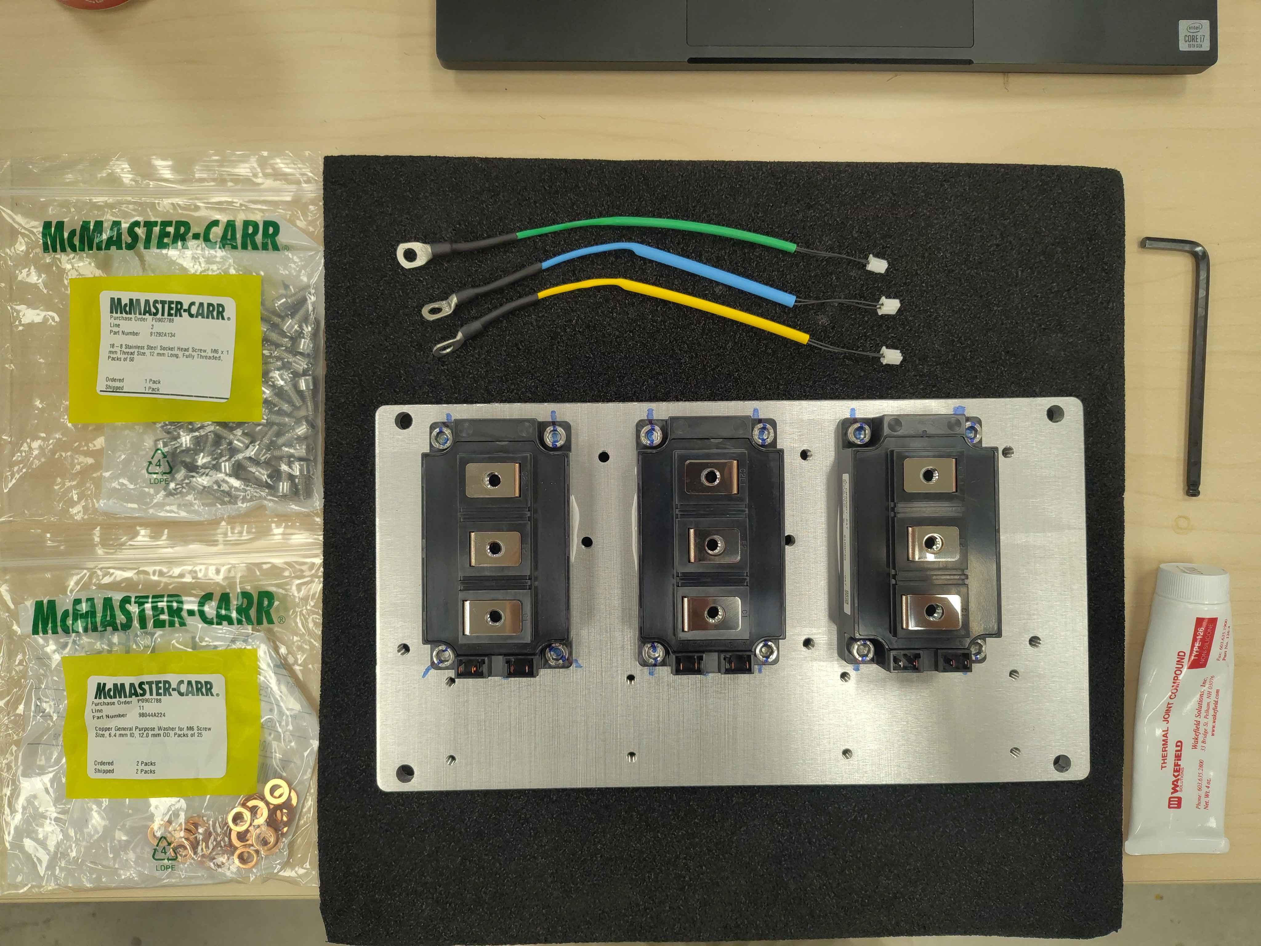 Temperature sensors, screws, washers, and thermal paste laid out