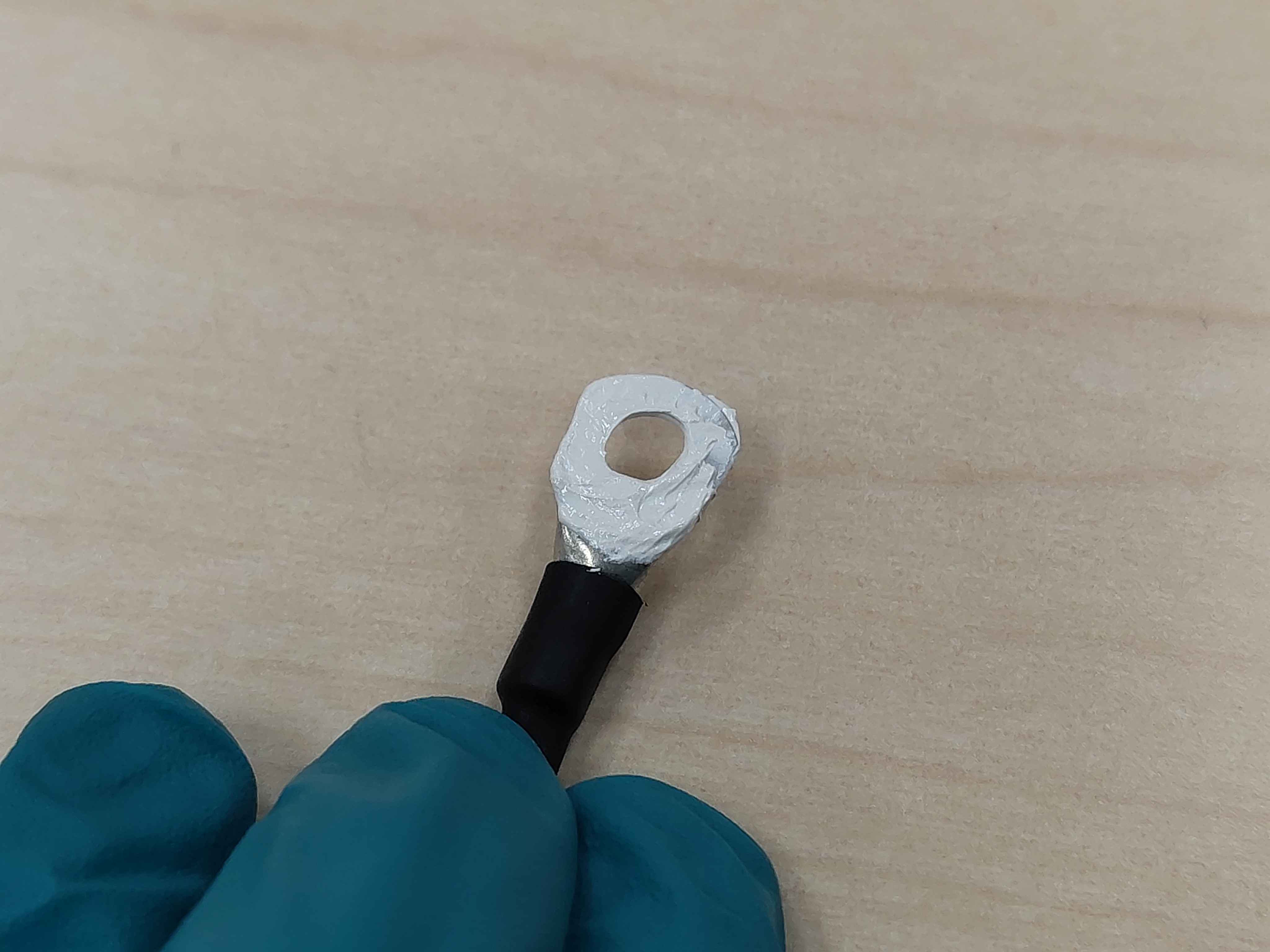 Thermal paste being applied to the underside of the ring lug