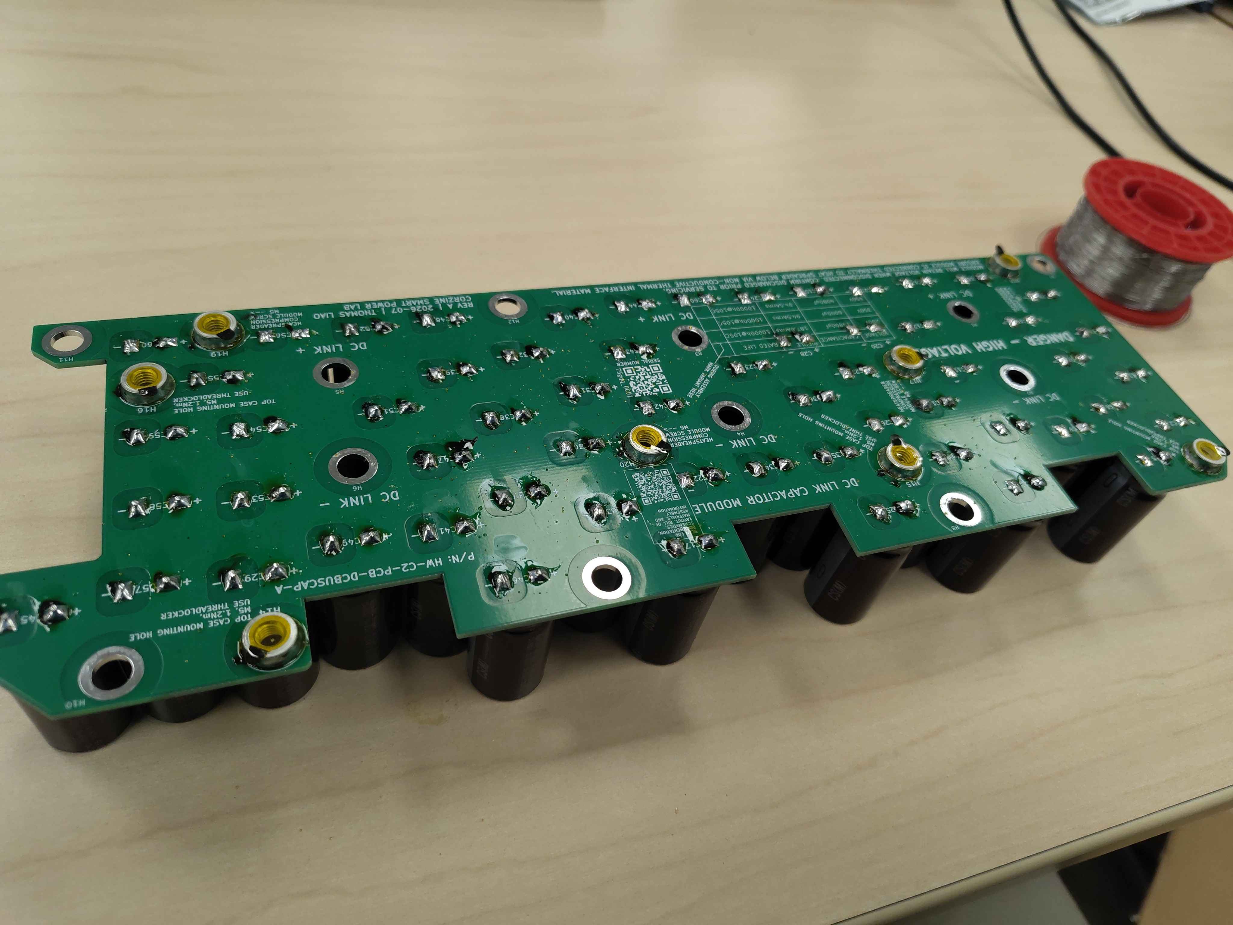 Bottom of the board with all capacitors soldered and leads trimmed