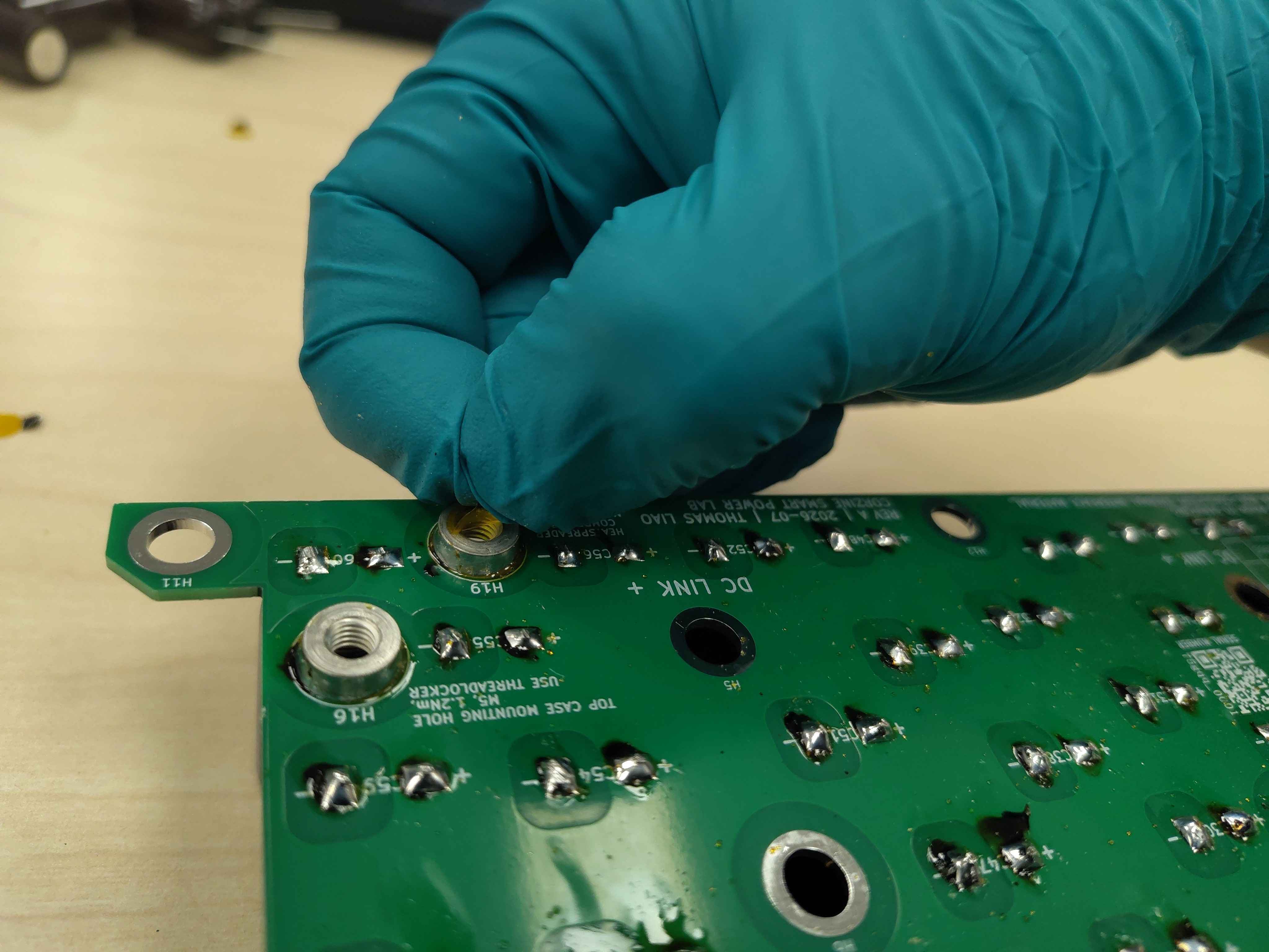 Peeling the pre-applied tape off a standoff after assembly