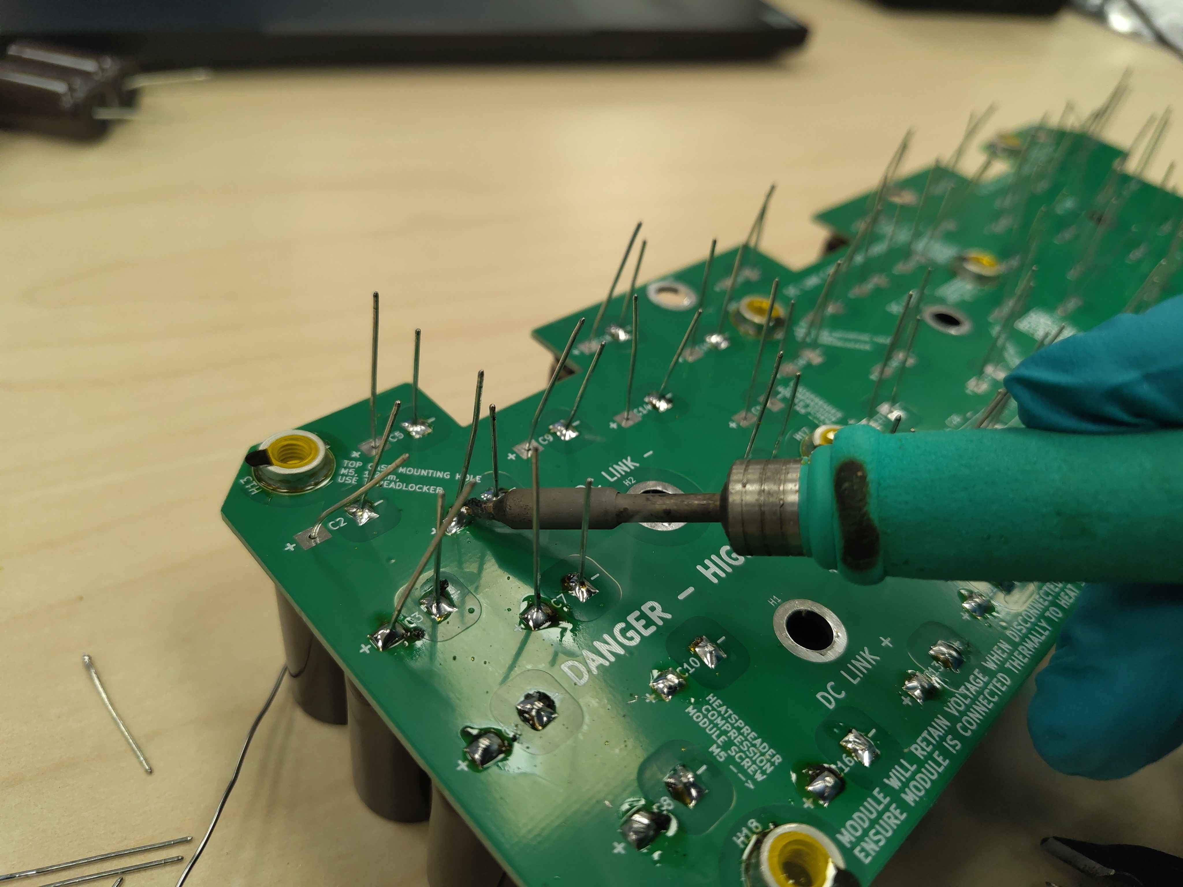 Soldering the remaining capacitor leads on the bottom of the board