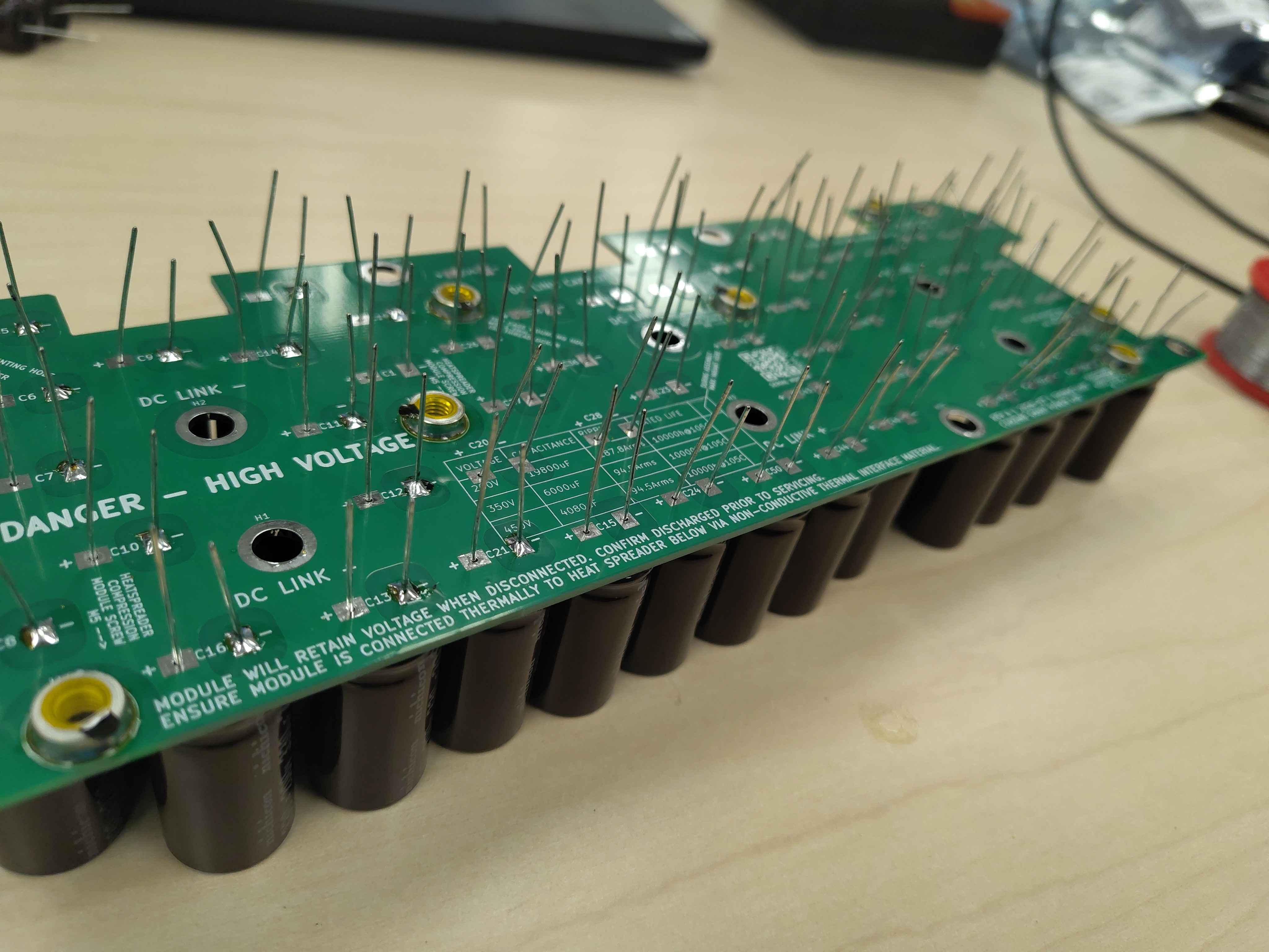 Tack-soldering one lead of each capacitor to lock them in place