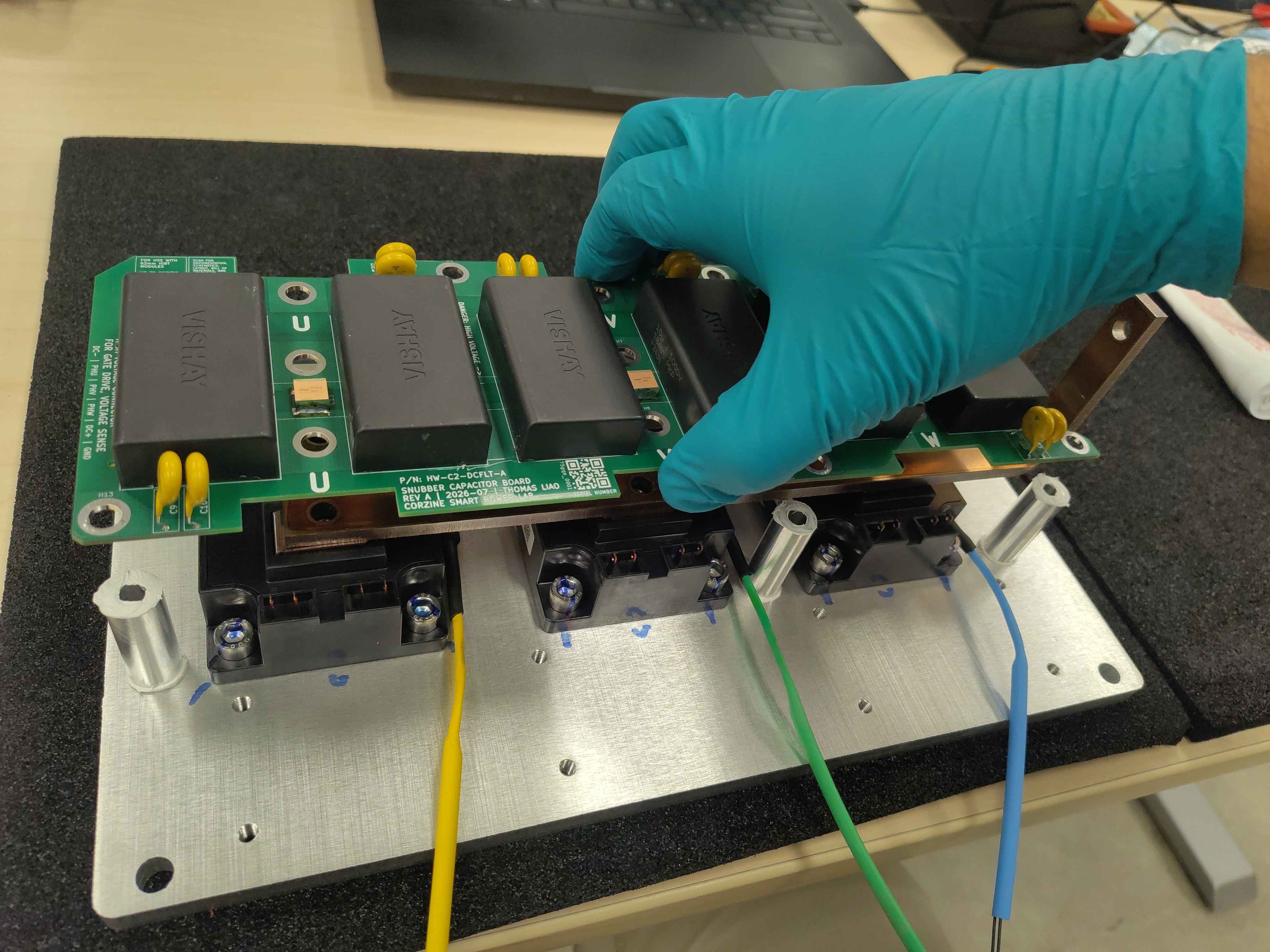 Lowering the DC-link filter board onto the spacers and bus bars