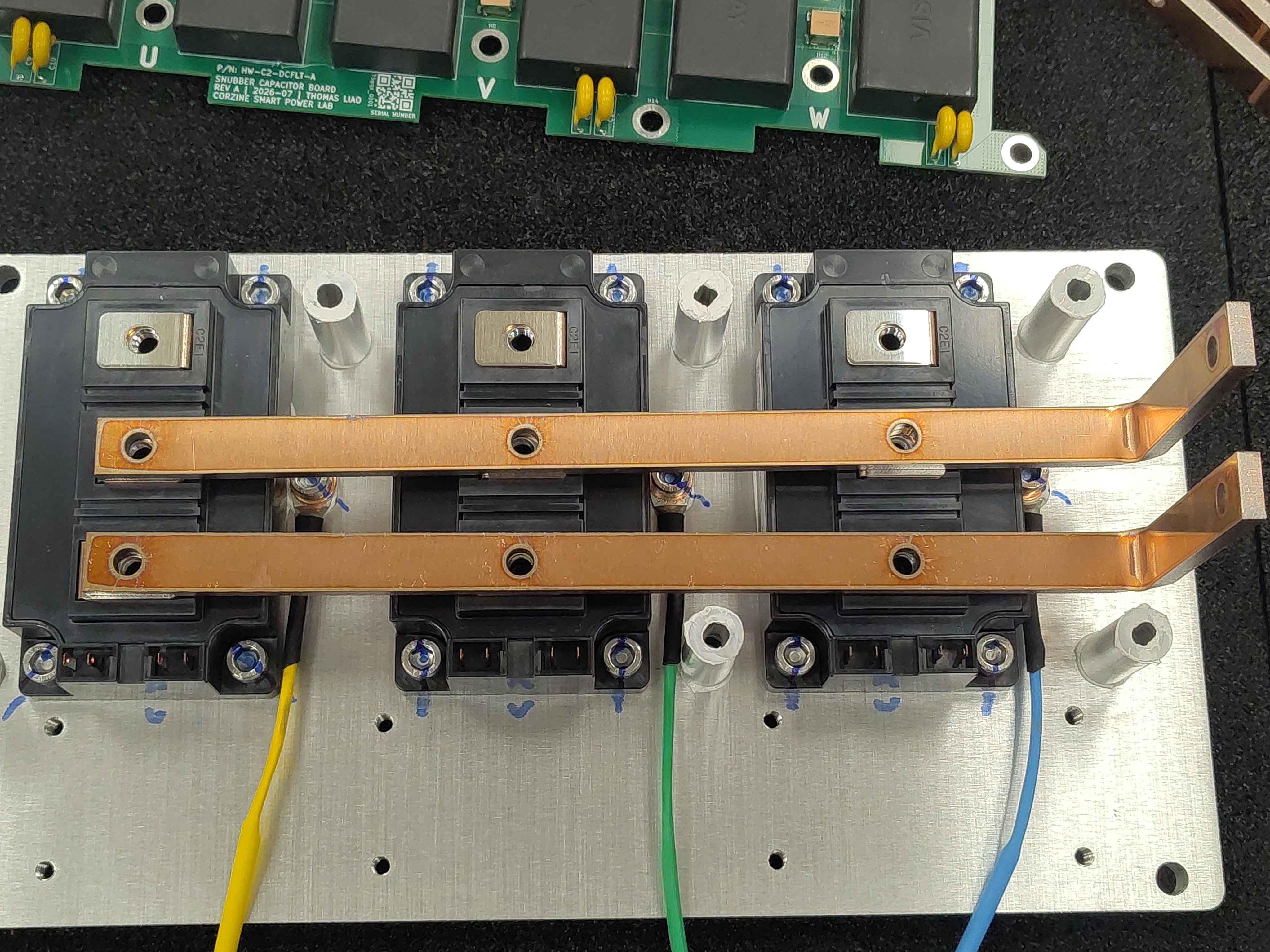 Both DC-link bus bars resting on the IGBT modules, viewed from above