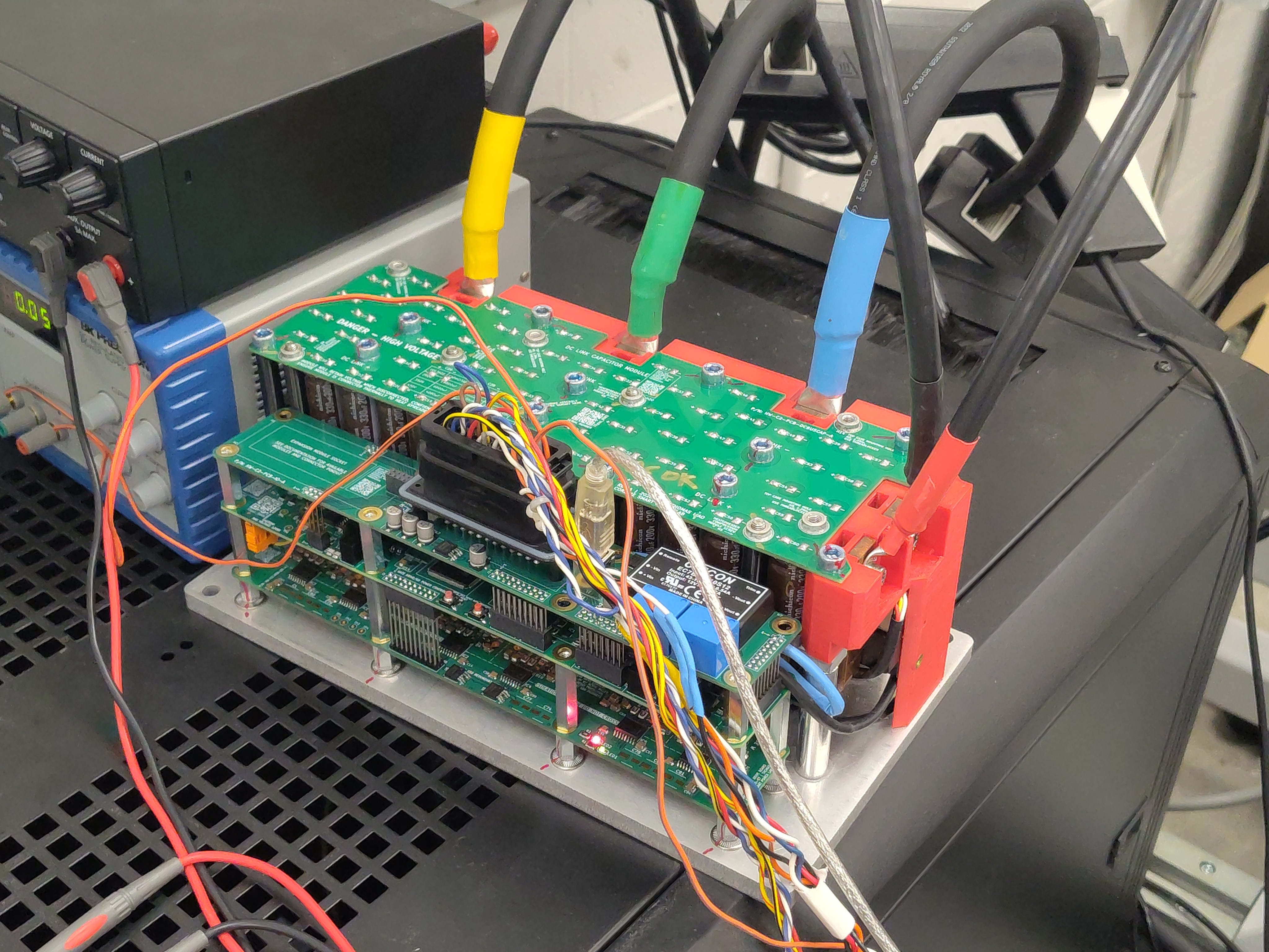 DUT close-up: bare OpenVVVF power-stage stack on an aluminum plate, no heatsink or fan